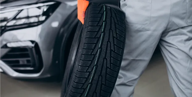 Employee holding a tire