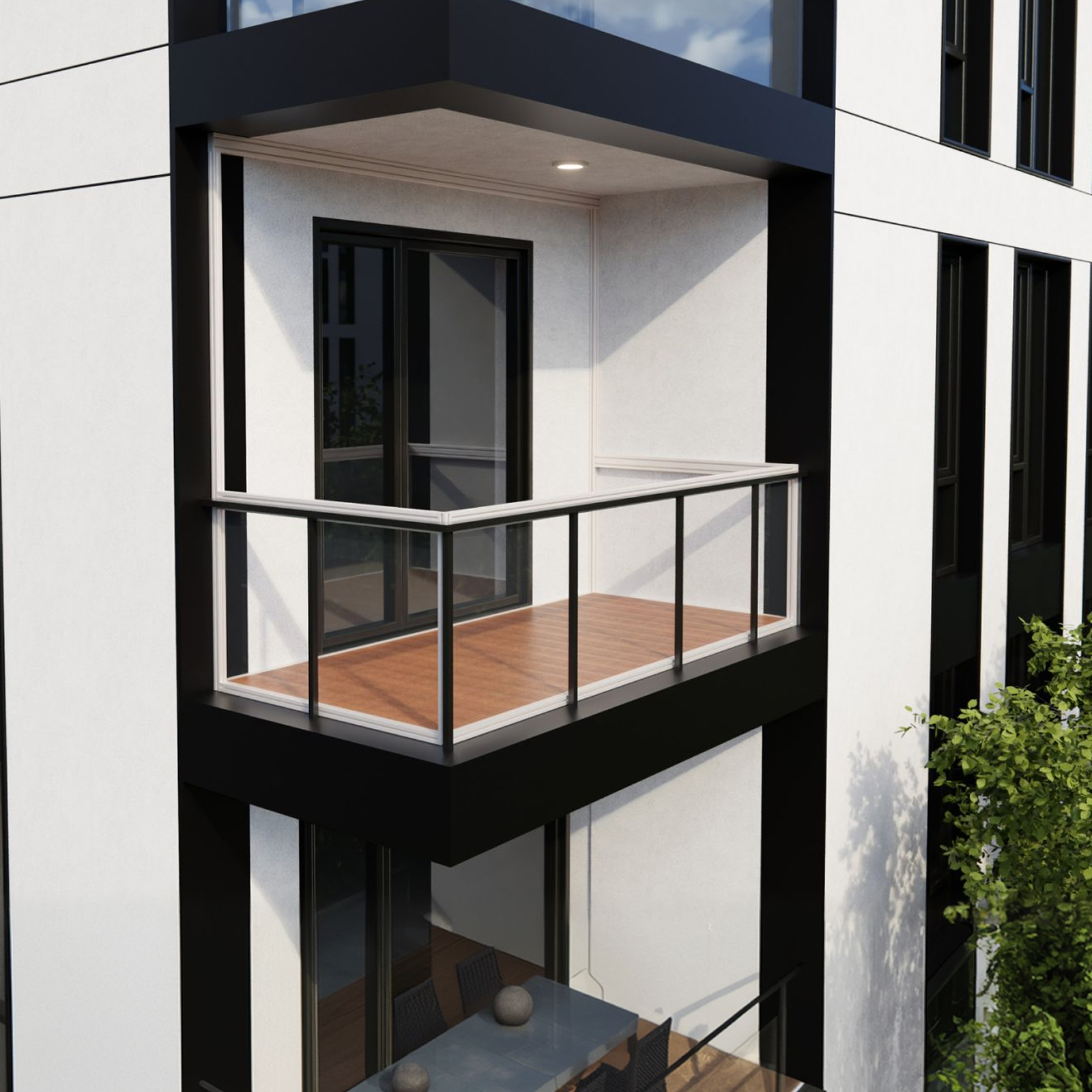 Modern balcony with transparent glass railing and black metal supports attached to a white building with dark sliding doors.