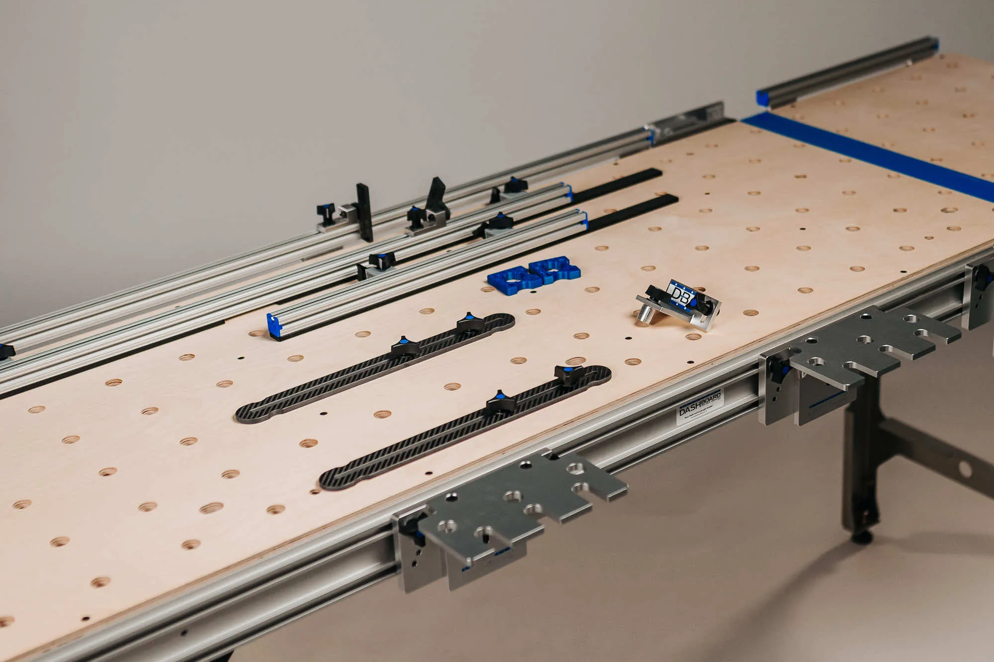 Dash-Board portable workbench with accessories laid out on top