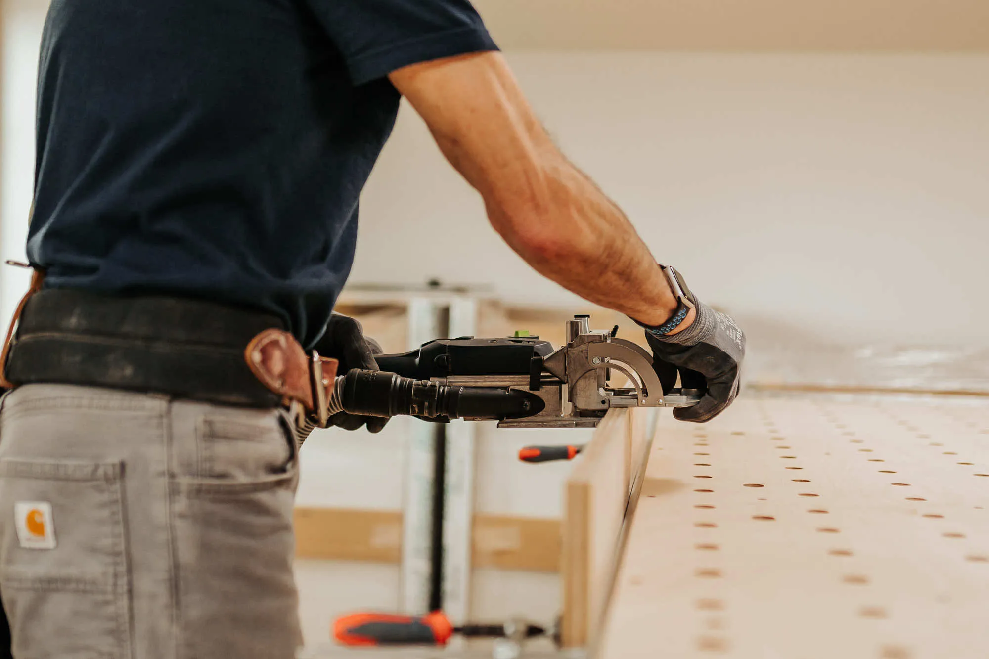 Man attaching a side accessory onto a workbench
