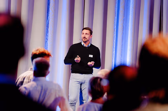 Bart speaking on stage in front of an audience.