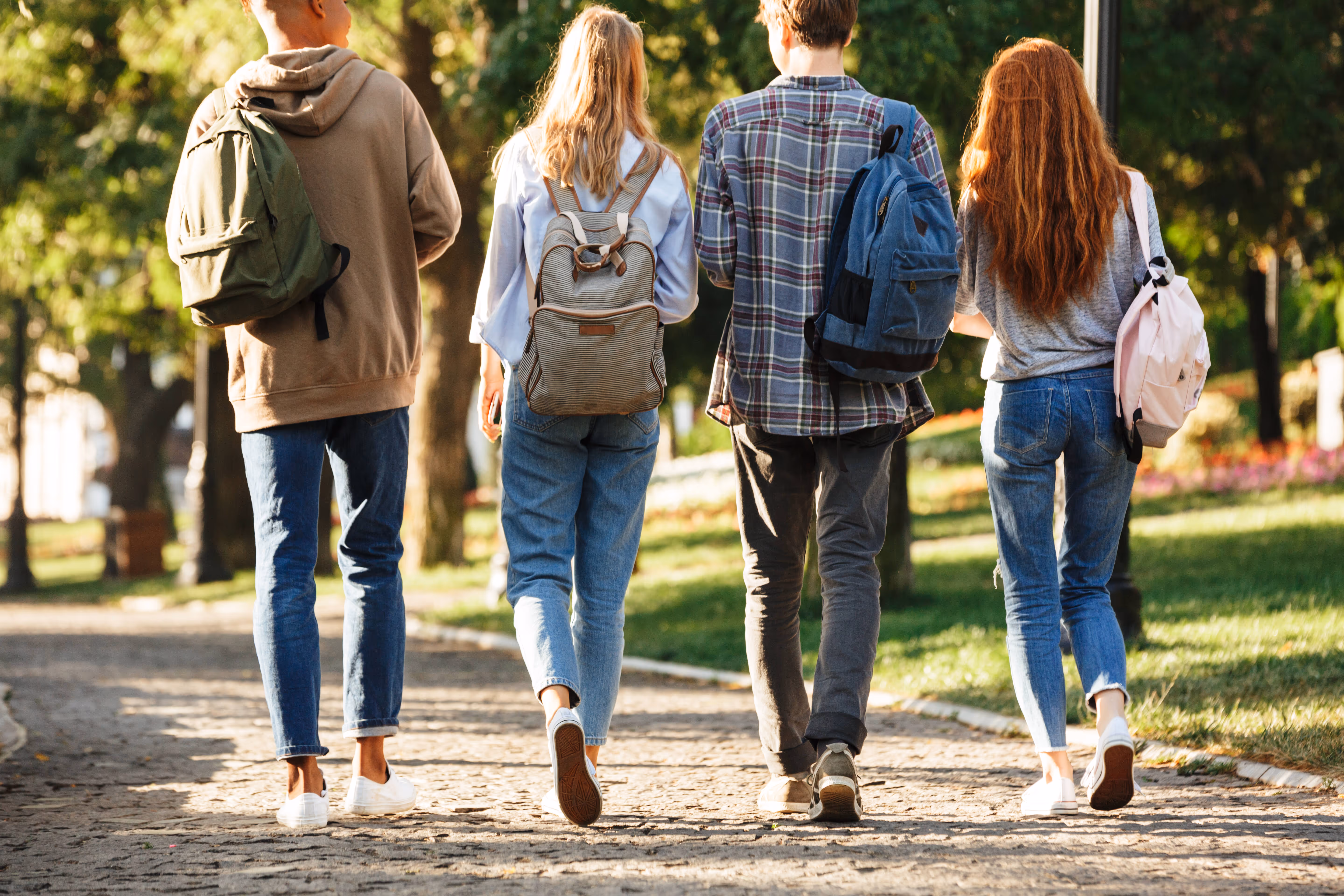 a group of student walking together with backpacks on