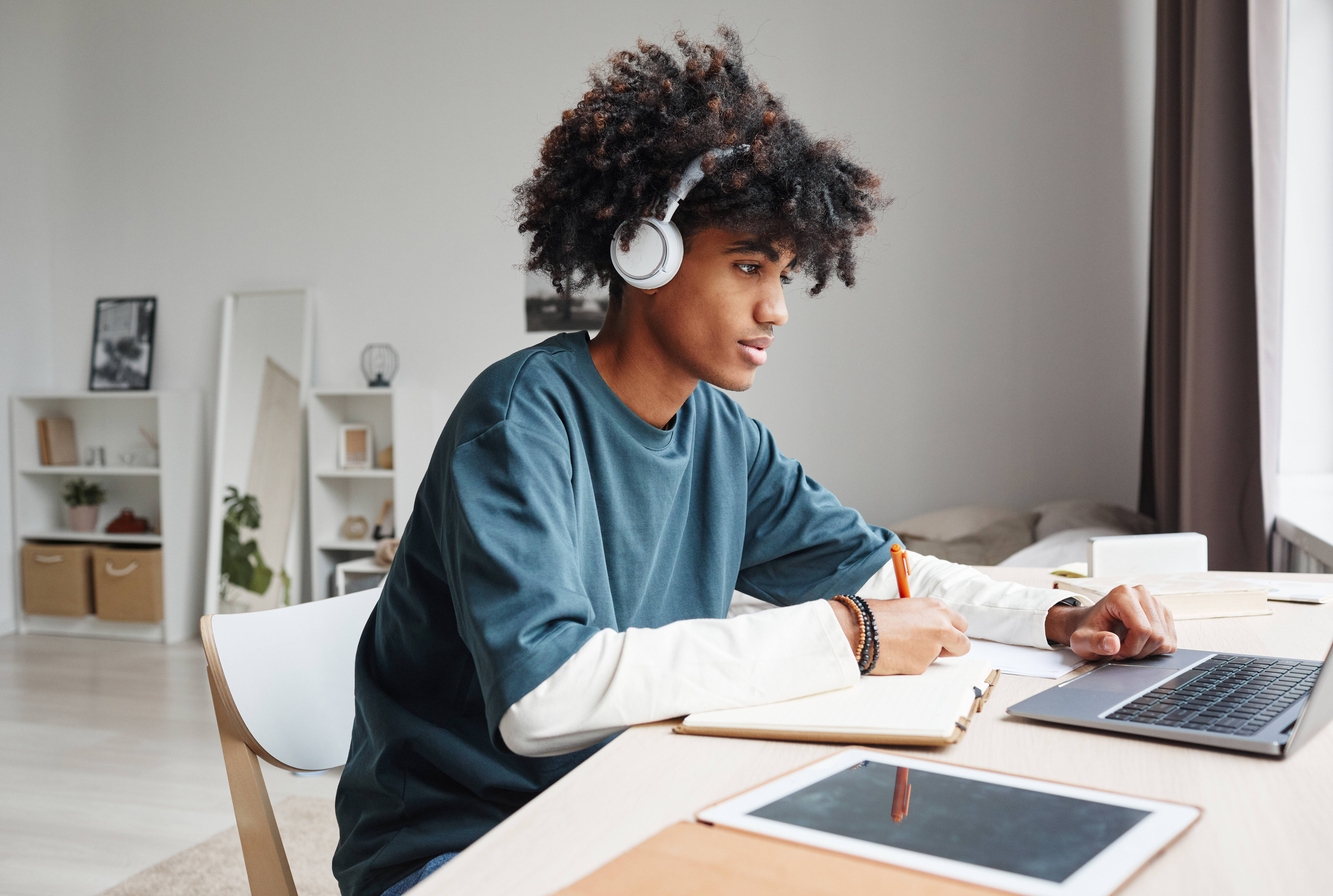 student in apartment at desk studying