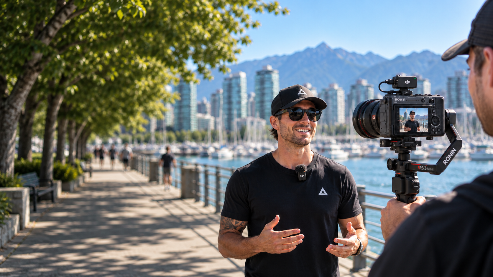 A business interview on Vancouver’s waterfront, with the skyline and mountains behind the camera