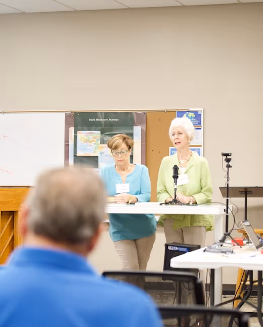 Two women presenting at a community meeting or conference