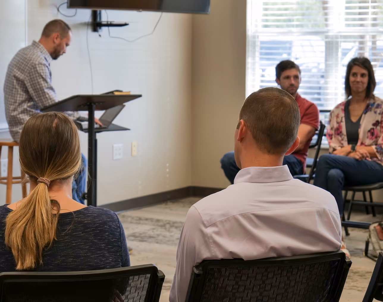 Business meeting with presenter and participants in office setting
