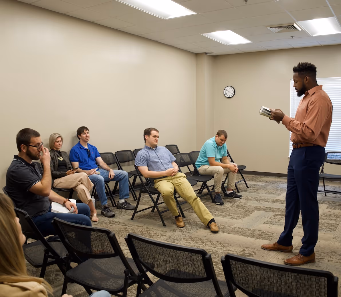 A man standing in front of people in a classroom teaching one of the Single Adults Connect Groups