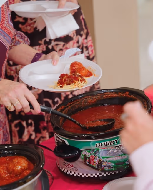 Singles ministry gathering, serving spaghetti with Bobby-branded sauce