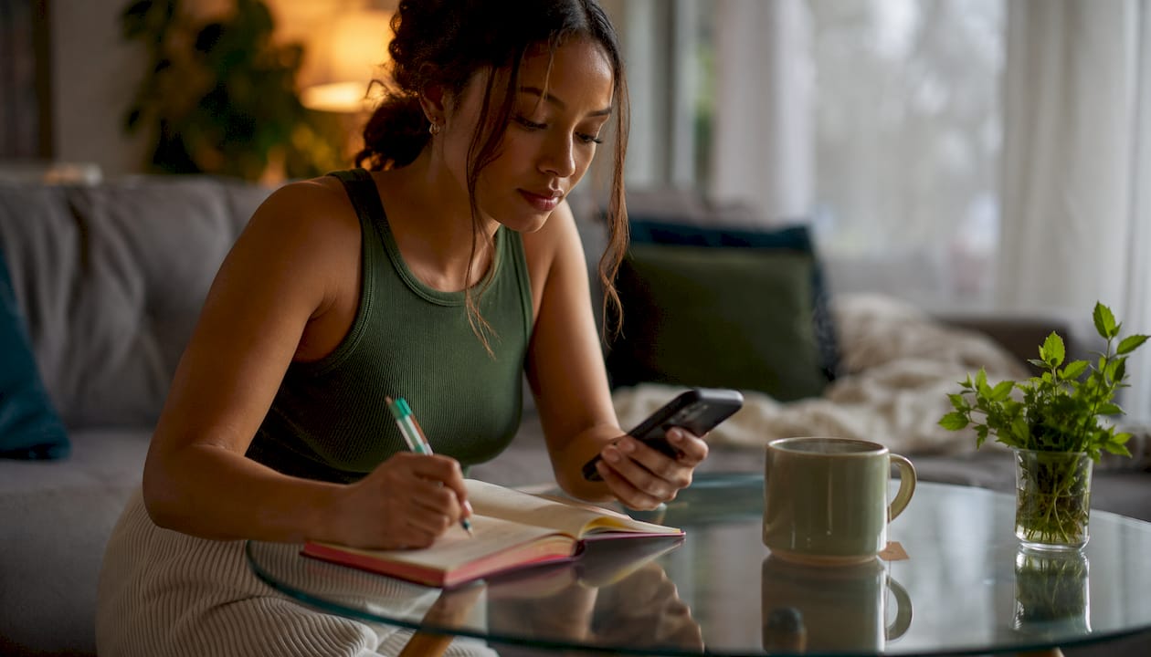 Woman logging anxiety symptoms on phone