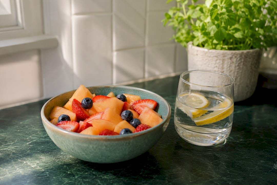 Pouring water with cucumber and watermelon