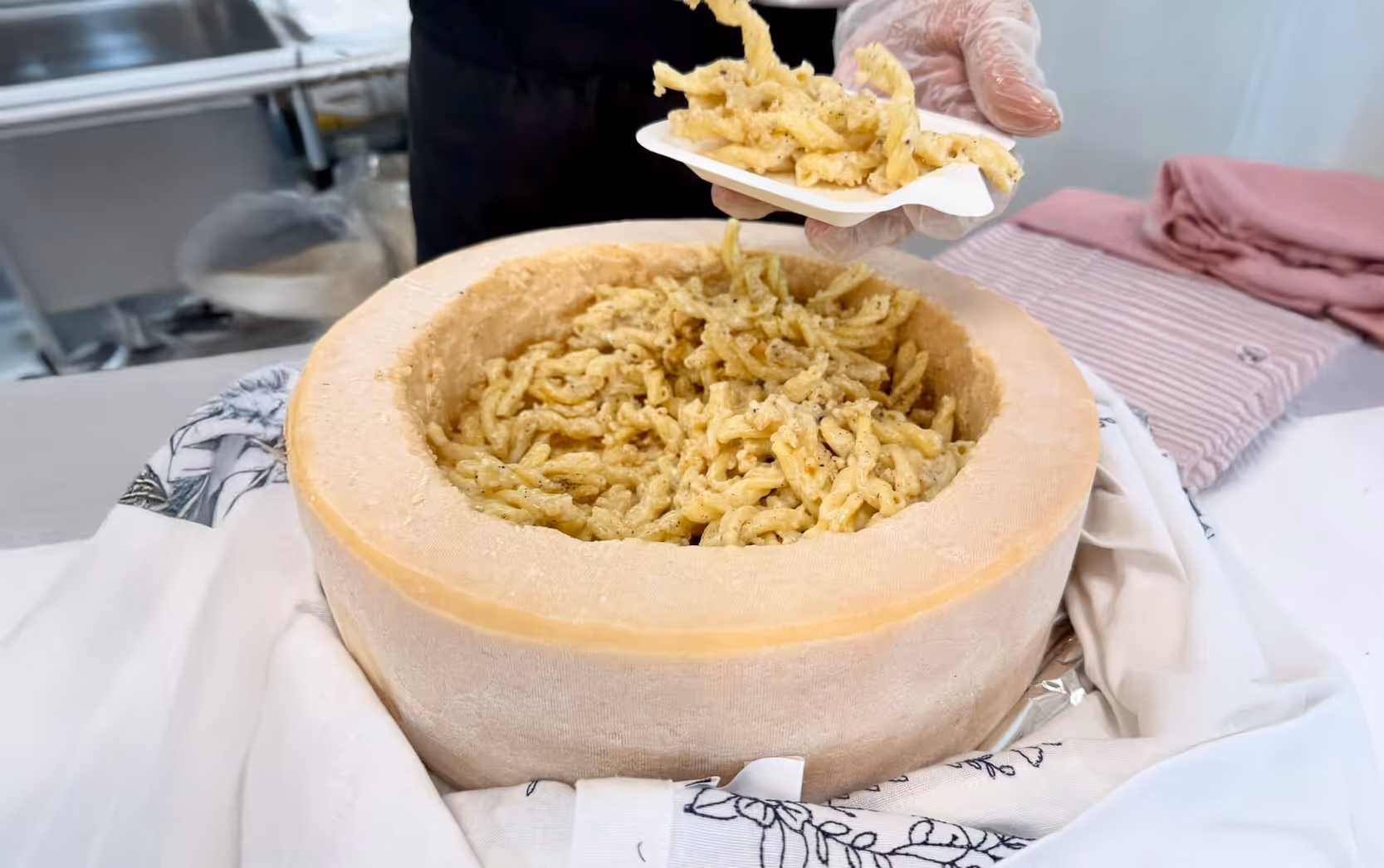 Pasta in a wheel of parmesan cheese.