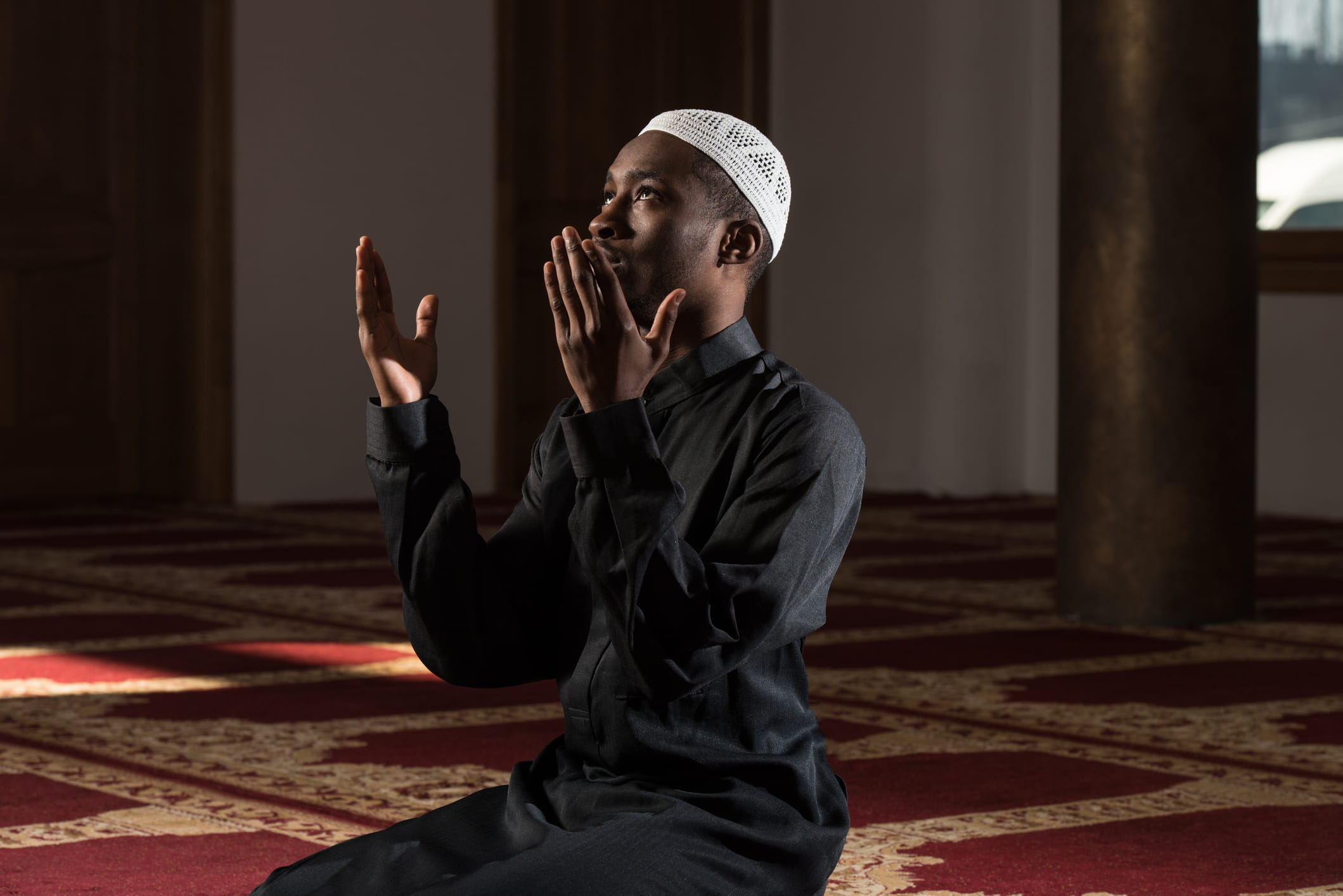 A Muslim man praying in a mosk