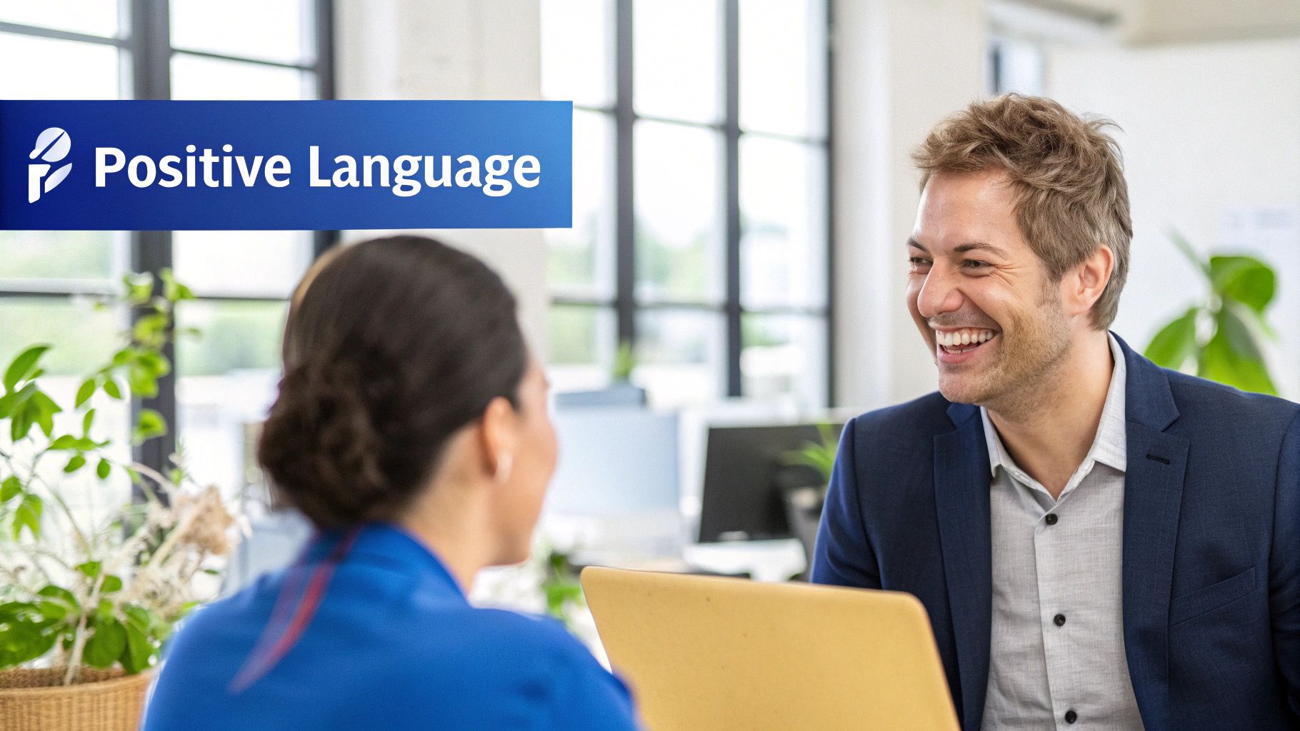 Colleagues having a positive, constructive conversation at a desk.