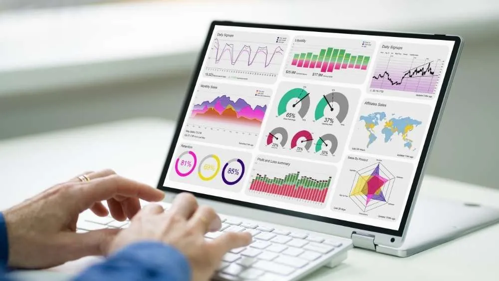 Person reviewing charts on a laptop; illustrative analytics image
