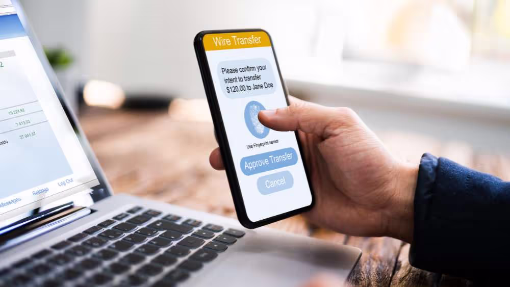 Person entering a verification code using a smartphone
