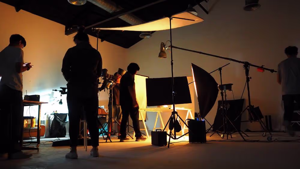 Production crew working with lighting in a studio
