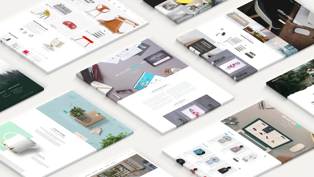 Printed website layouts spread across a desk