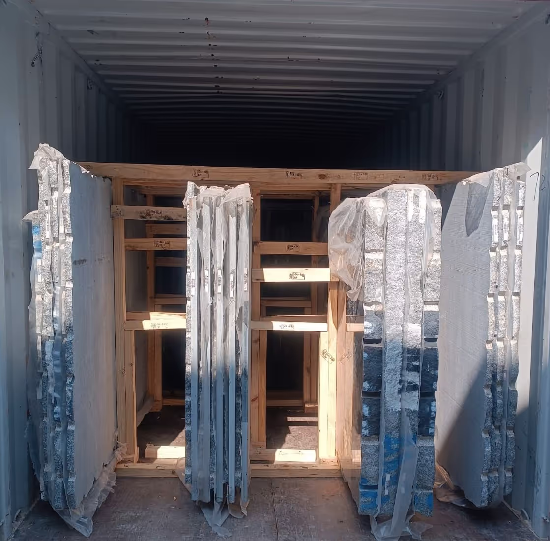 Granite slabs packaged and secured in a shipping container ready for international export