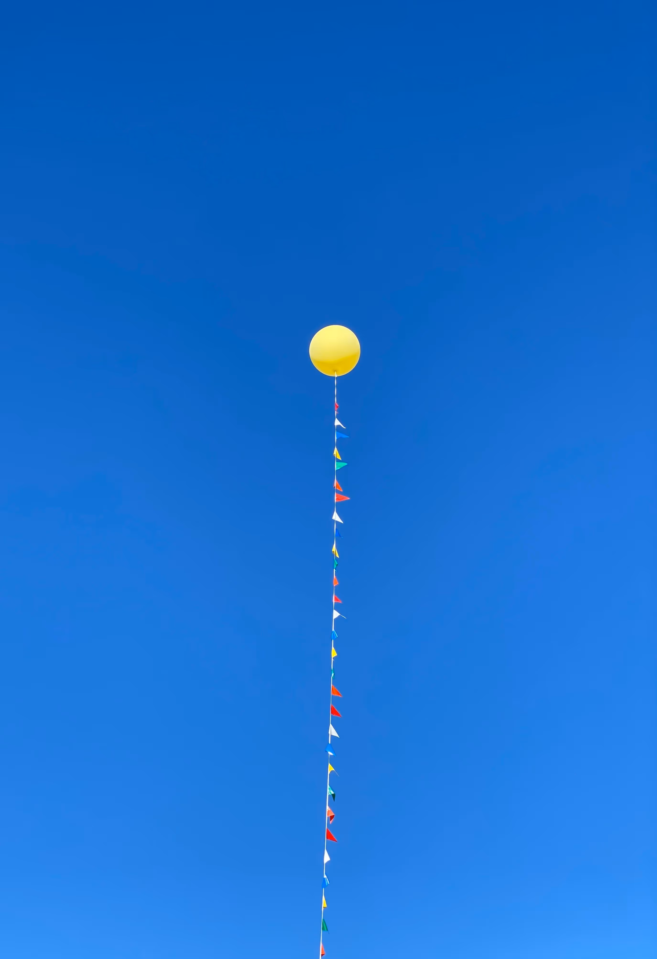 Balloon with a string representing feeling anchored and not flying away