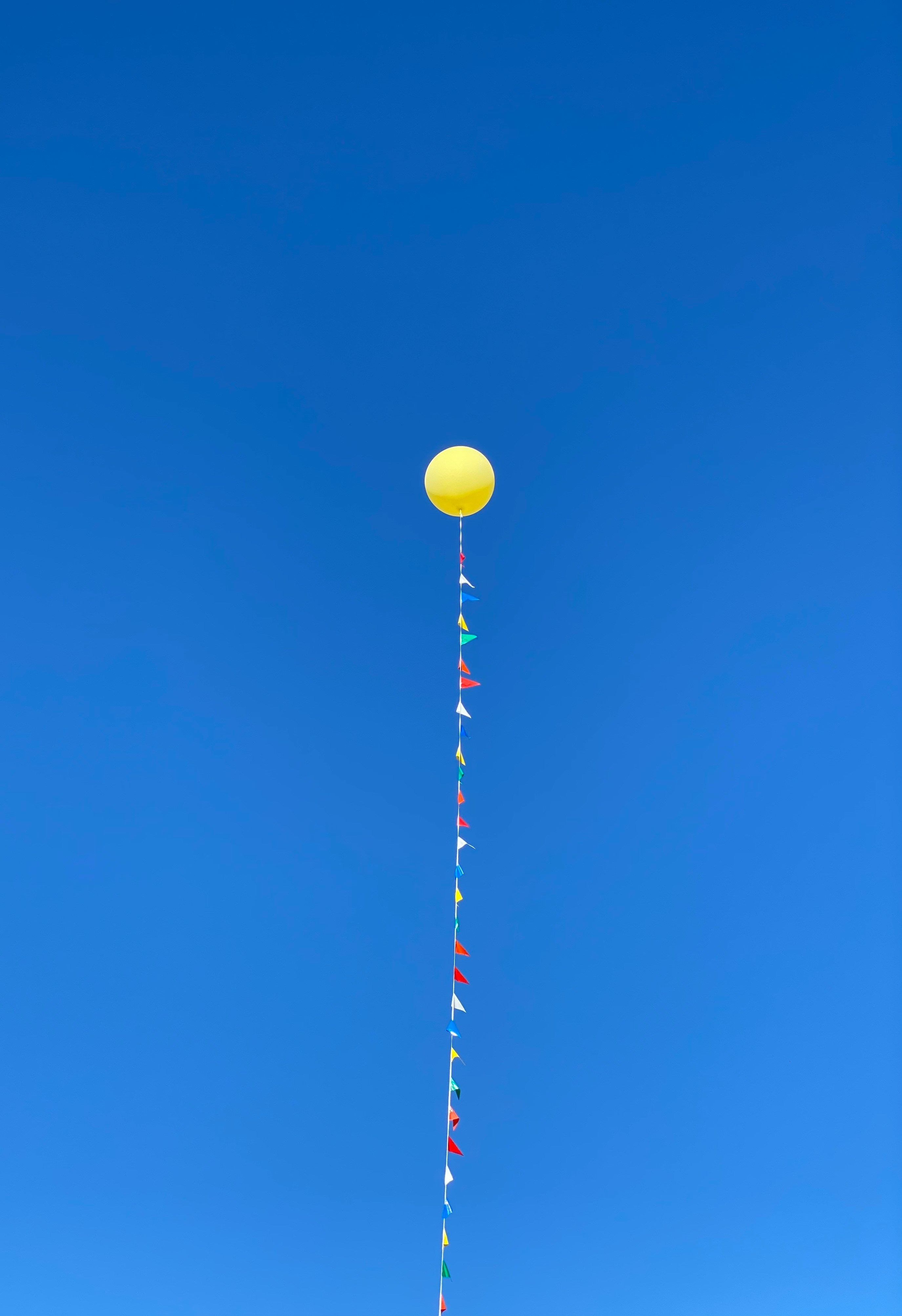Balloon with a string representing feeling anchored and not flying away