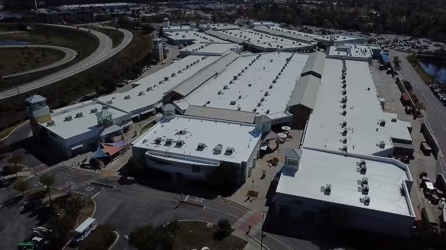 A large commercial building with a white membrane roof.