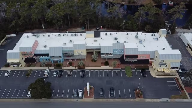 Aerial view of a large commercial building with a low-slope roof in Myrtle Beach, SC.