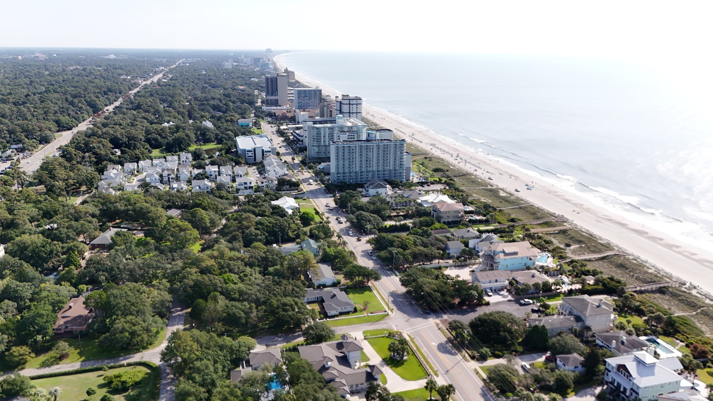 Aerial view of coastal commercial buildings along the beach.
