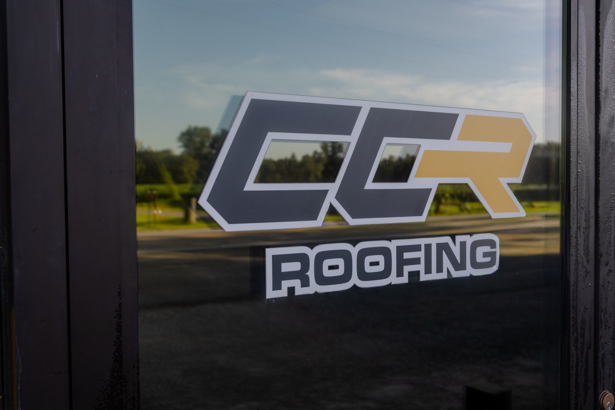 Large commercial building with a white low-slope membrane roof.