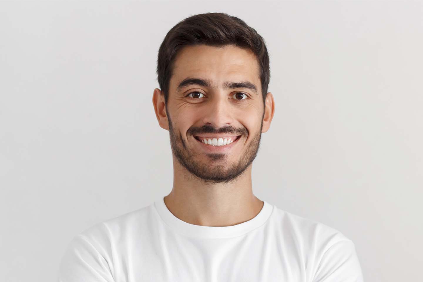 A man with a goatee smiles at the camera.