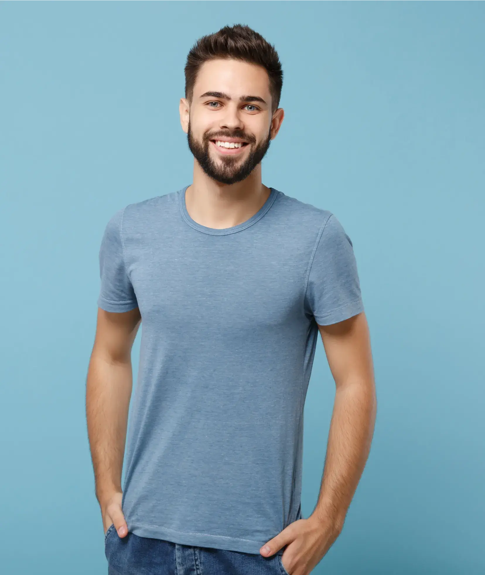 A smiling man in a blue t - shirt.