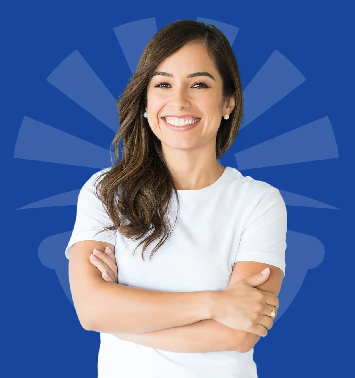 A woman in a white shirt smiles, standing with arms crossed against a blue background.