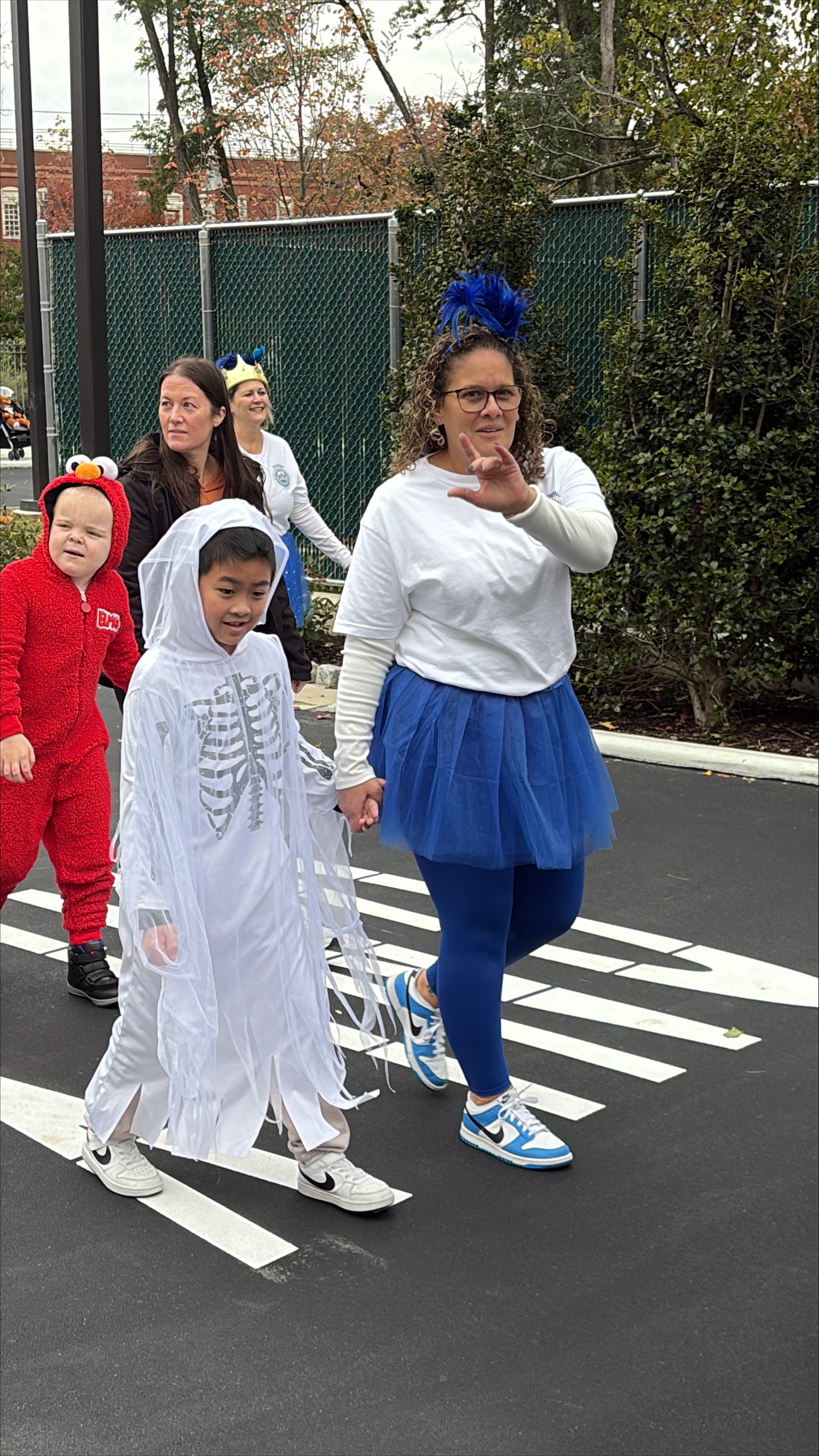Kids with teacher on road