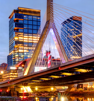 An image of a bridge in Boston with city building in view behind it.