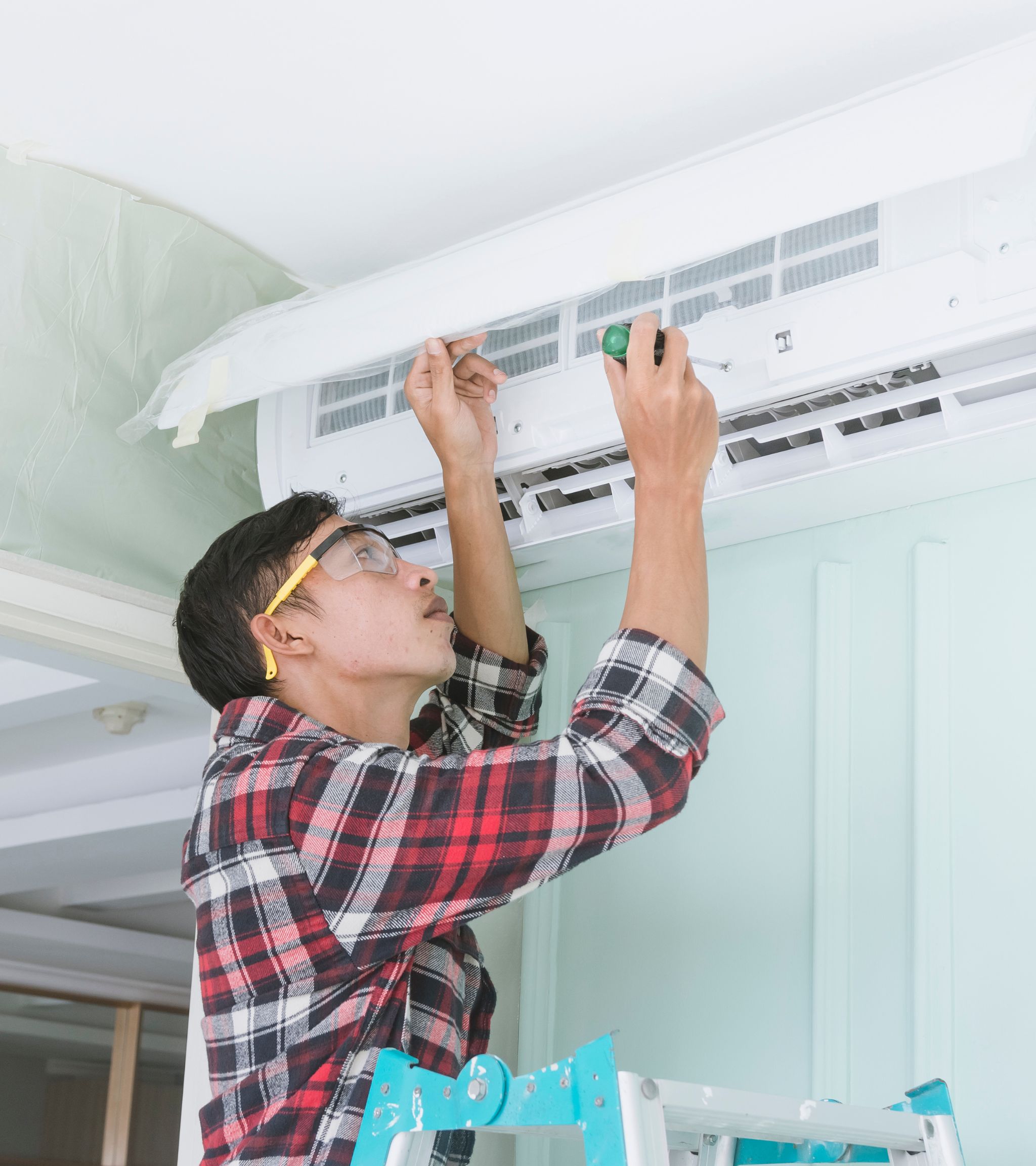 A man fixing an ac unit
