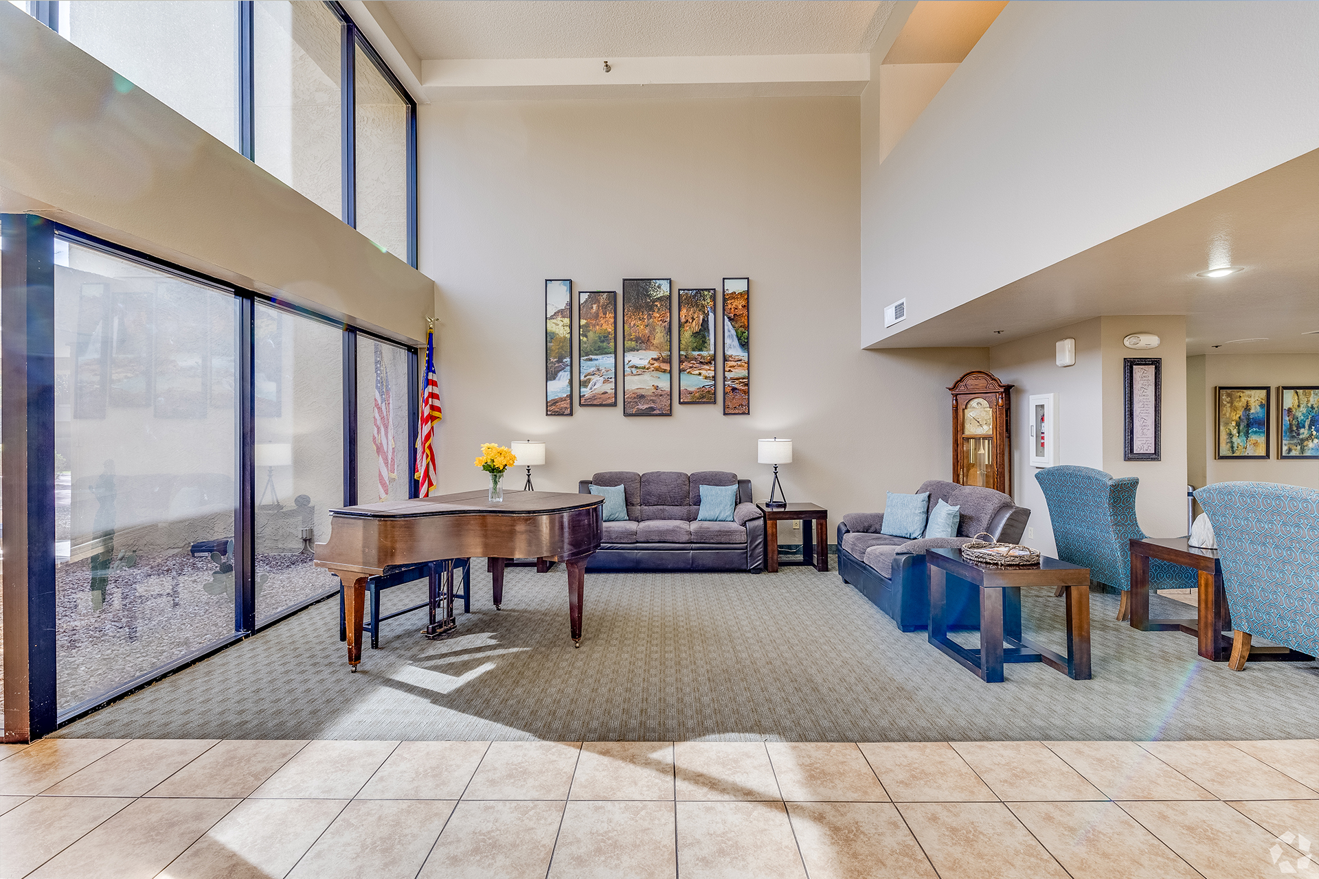 Lobby seating beside tall entrance windows — view 1 at LifeStream at Glendale.