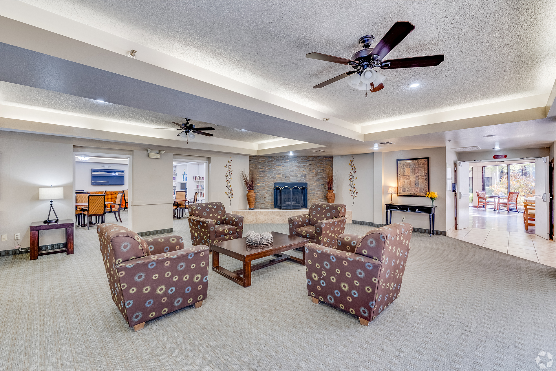 Shared lounge with television and armchairs — view 1 at LifeStream at Glendale.
