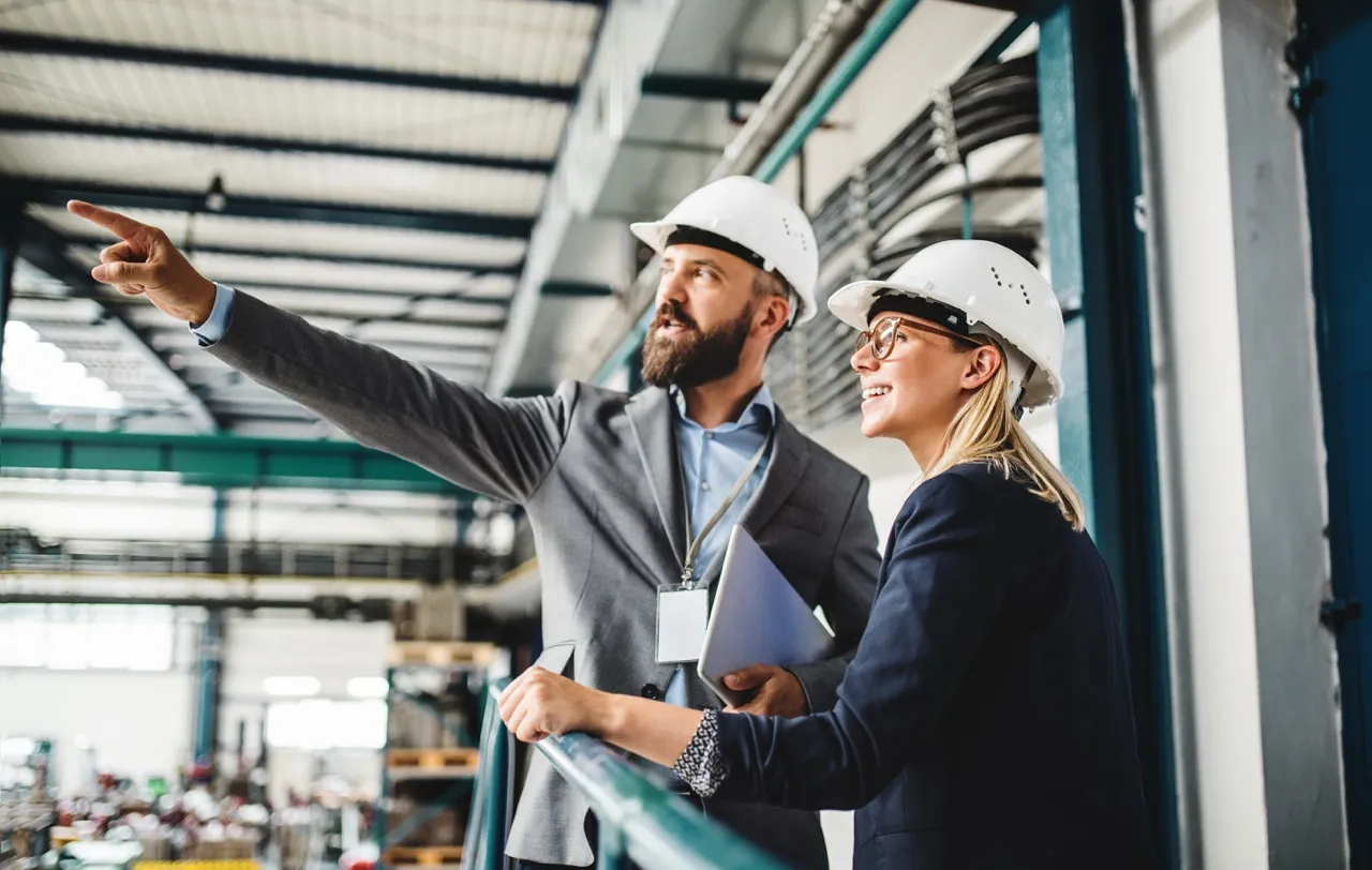 Two management workers looking over a construction site