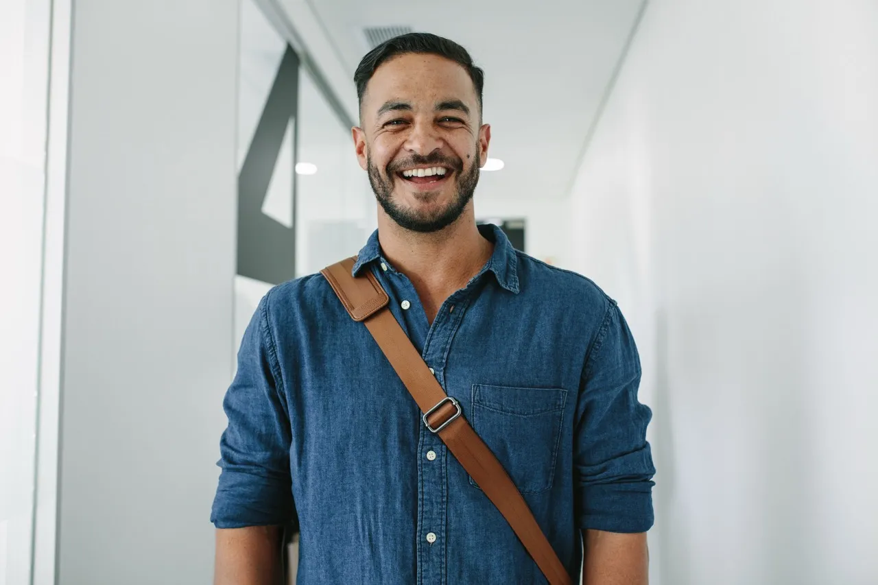 headshot of a man smiling at the camera