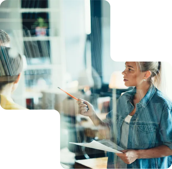 Woman in the workplace holding a pen and paper