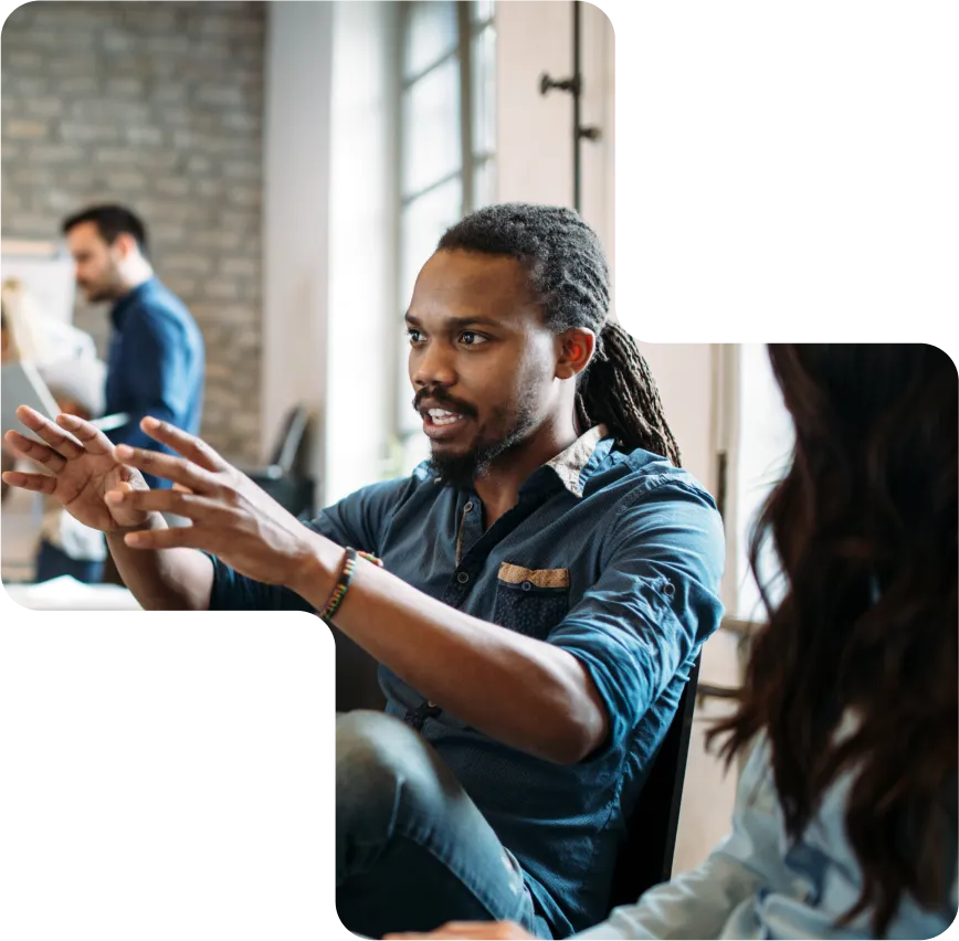 man in an office settings using his hands to help him communicate his vision