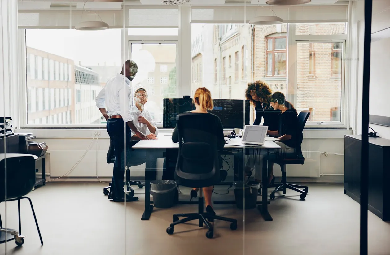 Group of coworkers collaborating in an office room 