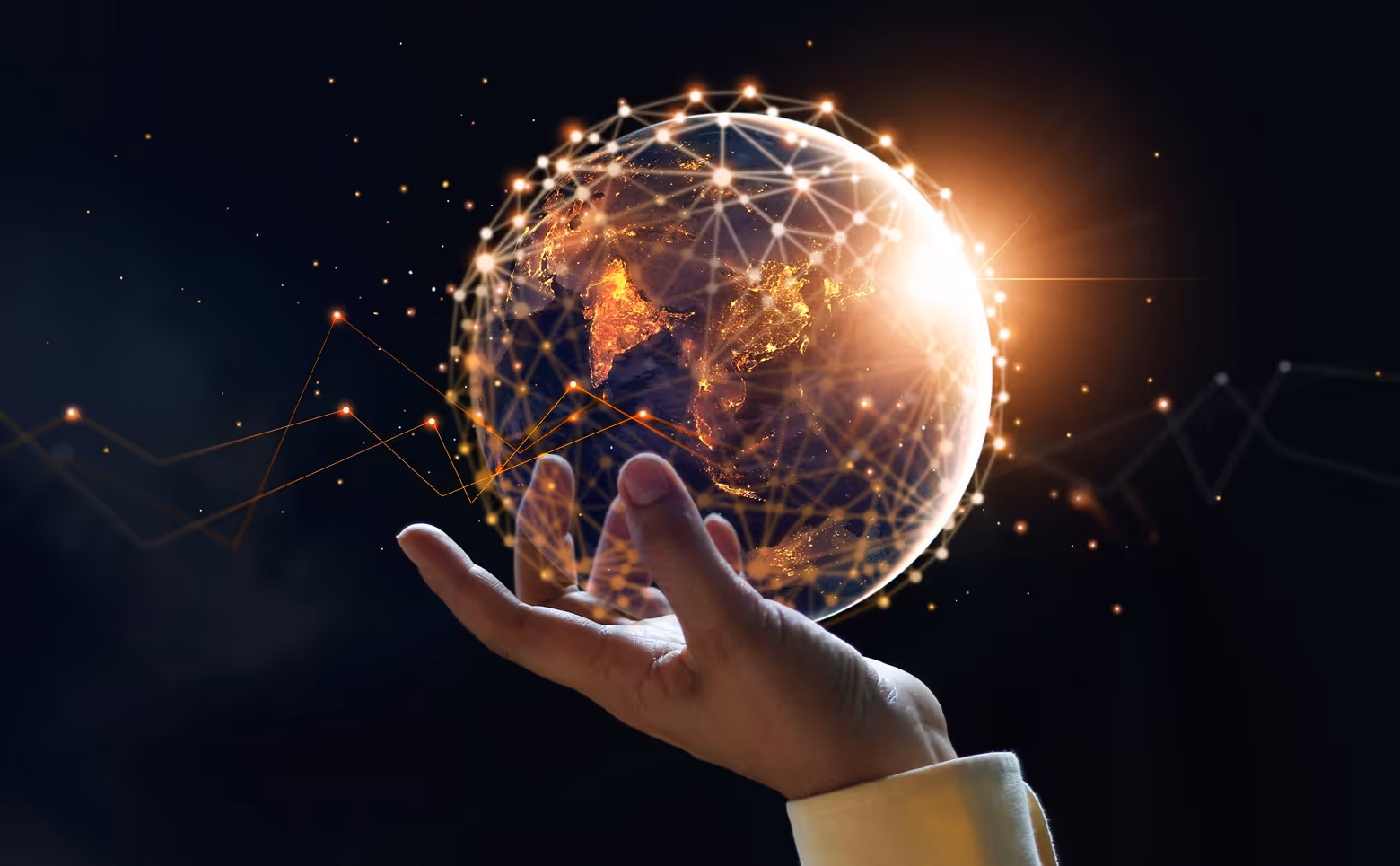 Hand holding a glowing digital globe with network connections and illuminated continents against a dark background.