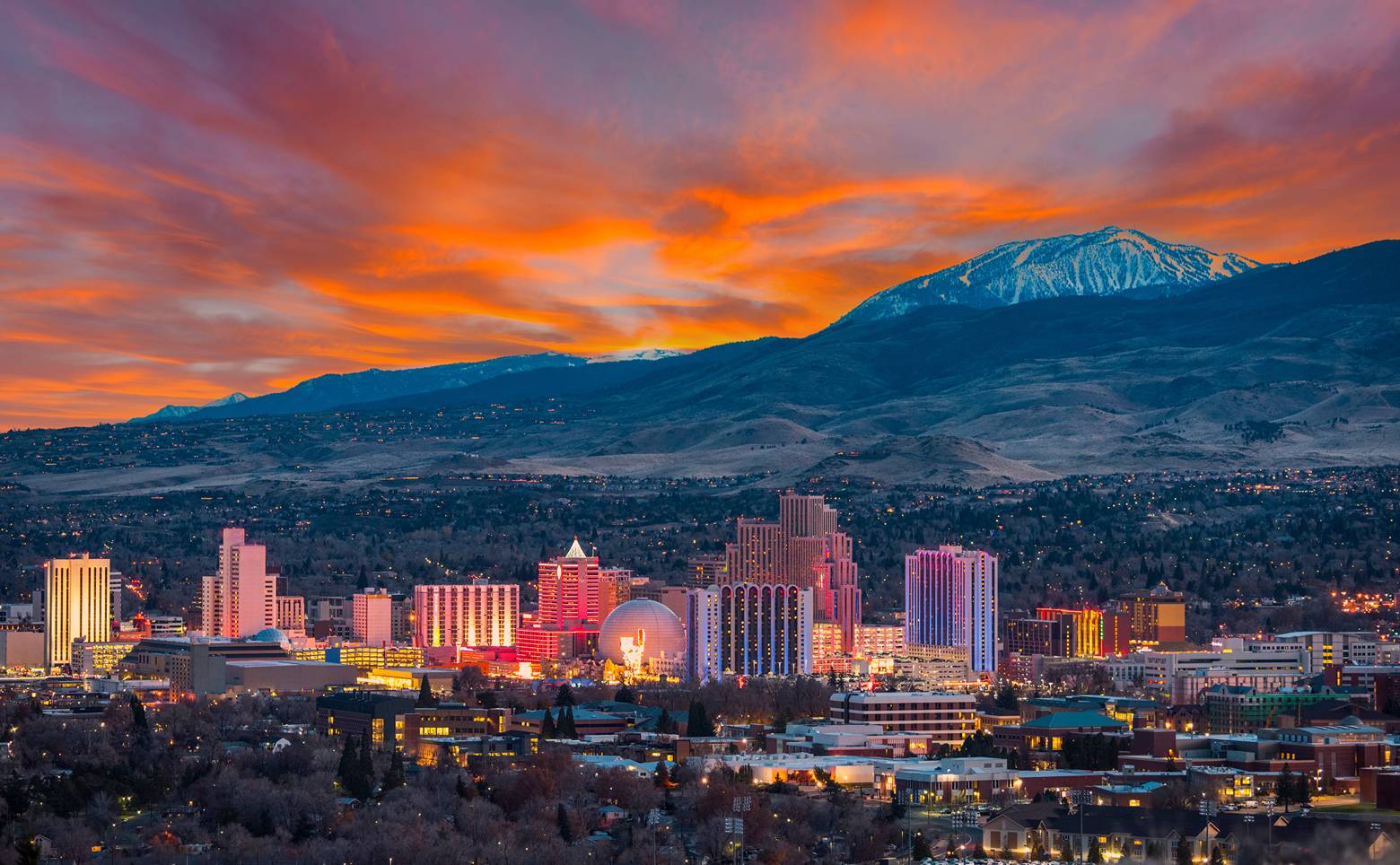 Reno, Nevada skyline at sunset with striking mountains in the background