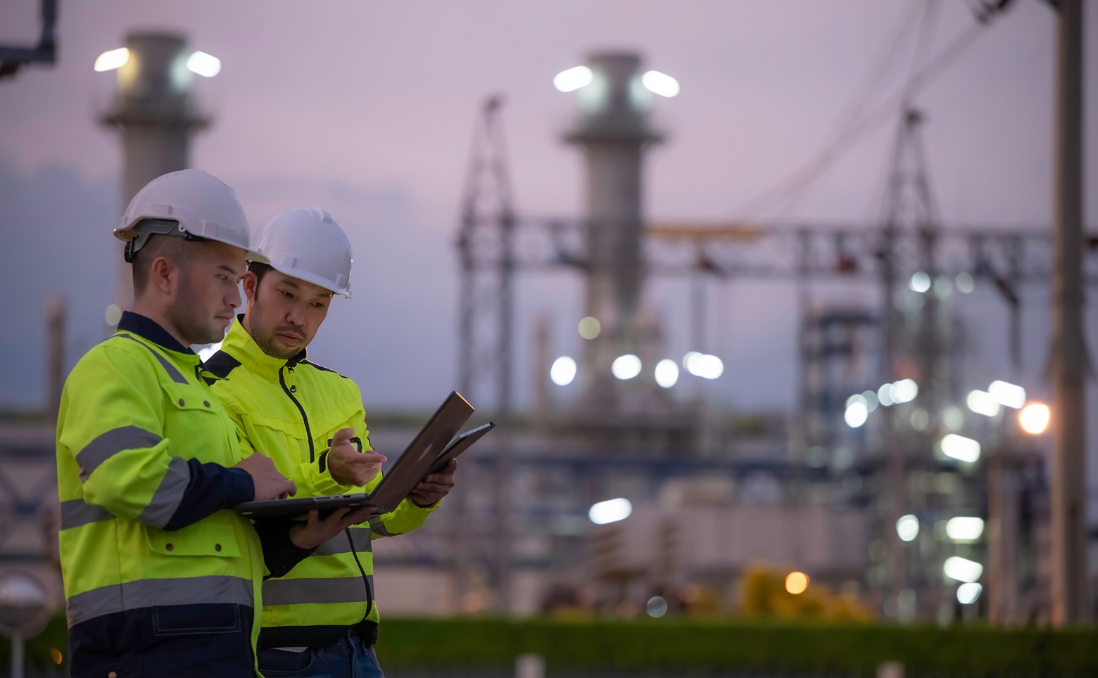 engineers in hi viz and hard hats oversee power grid