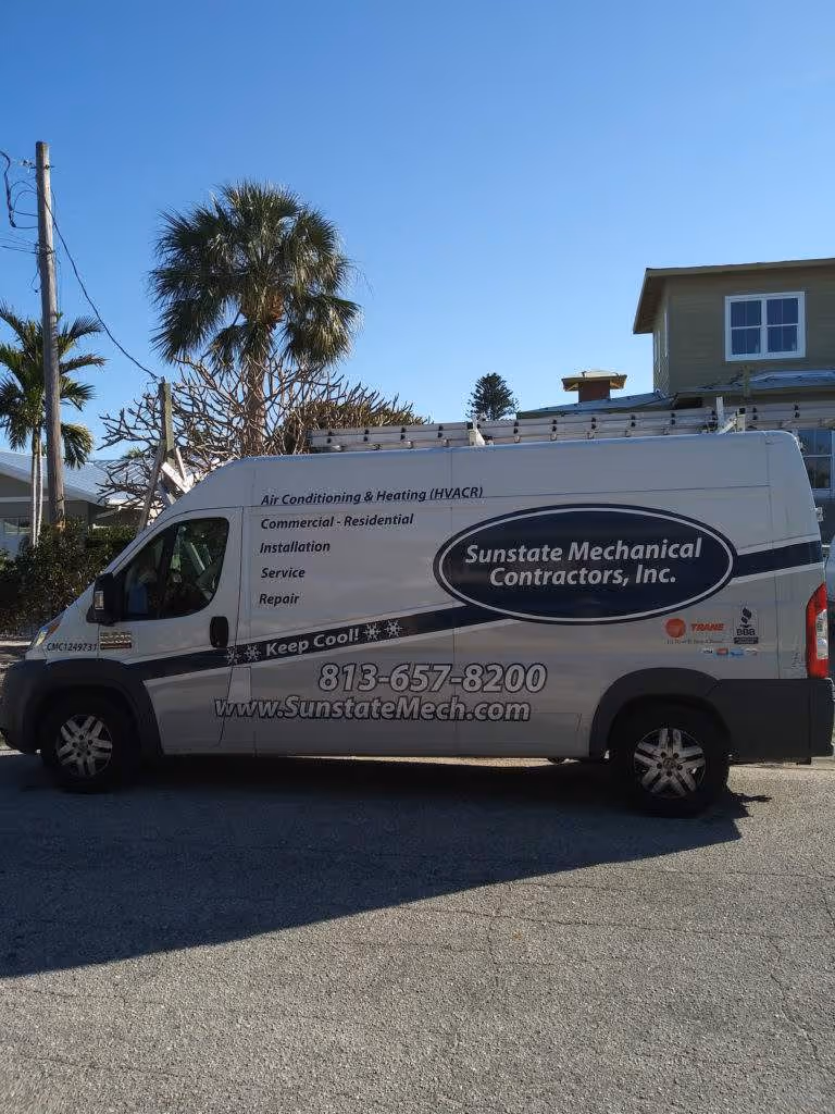 White Sunstate Mechanical Contractors van parked on street near palm trees