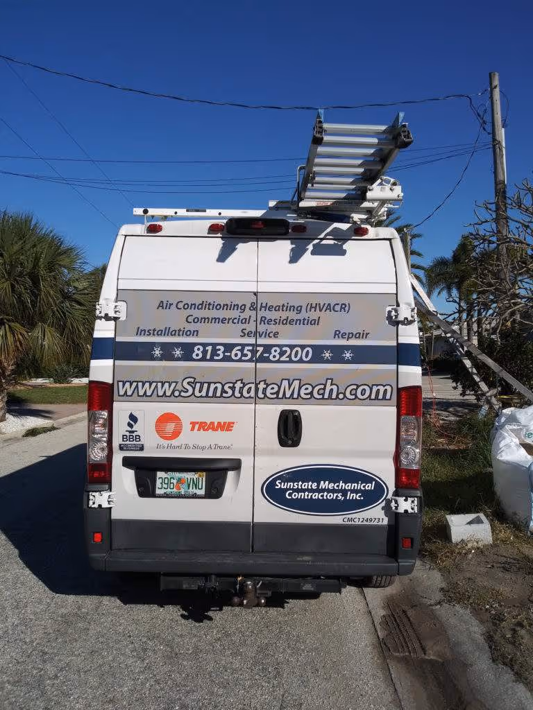 White Sunstate Mechanical van with ladder, parked on street