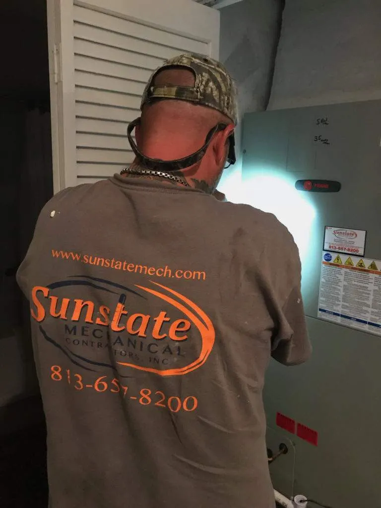 Technician from Sunstate Mechanical wearing work shirt, facing away from camera