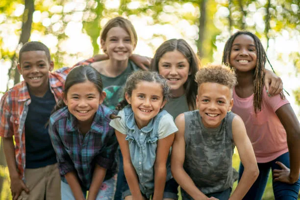 Image of a group of happy kids grouped together and smiling for the picture, with a promotion regarding Greensky financing options, Sunstate Heat and Air