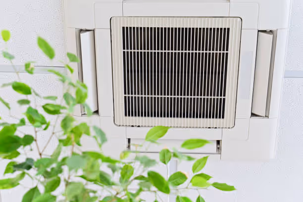 Air conditioning unit with green leaves, symbolizing clean and fresh air