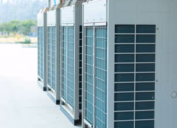 Large industrial air conditioning units lined up outside a building